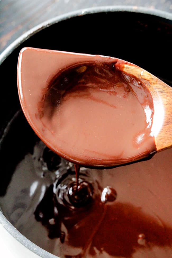 showing how to make chocolate ganache by stirring it with a wooden spoon once melted