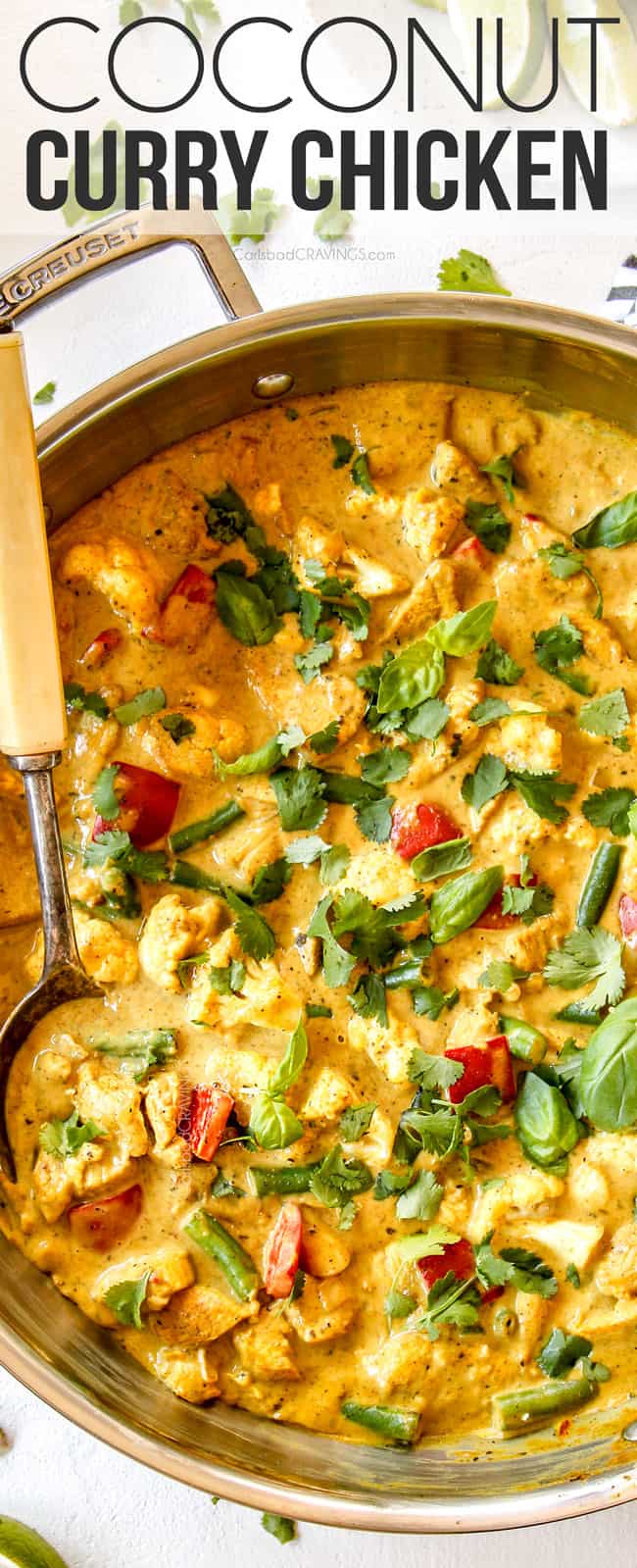 up close top view of creamy coconut curry chicken in a stainless steal skillet