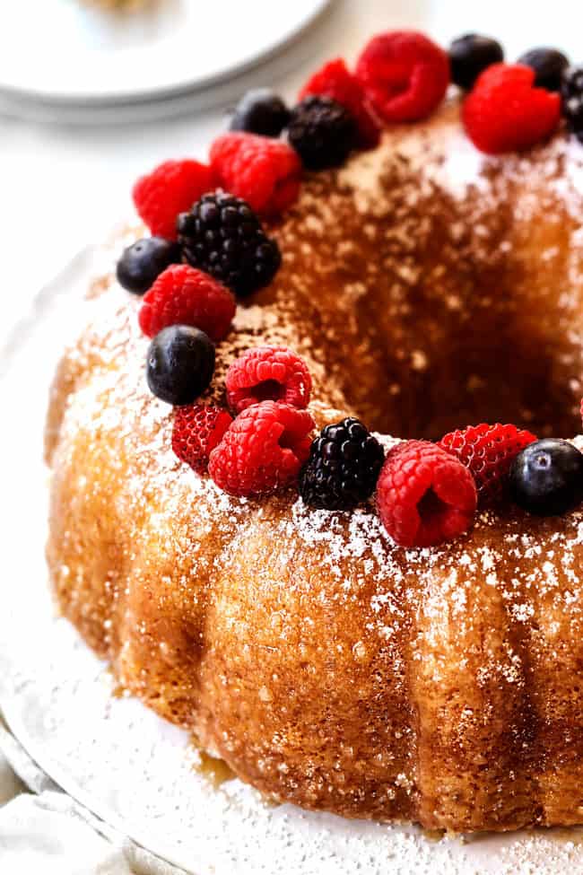 side view of rich Kentucky Butter Cake dusted with powdered sugar and topped with berries