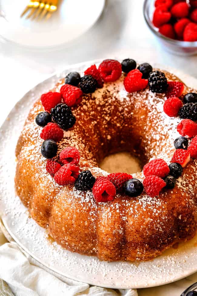 far away side view of Kentucky Butter Cake dusted with powdered sugar and topped with berries