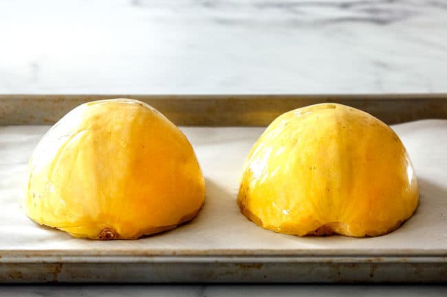 showing how to cook spaghetti squish by placing squash halves cut side down on a baking sheet