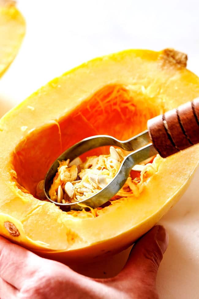 showing how to cook spaghetti squash by scooping out the seeds before cooking