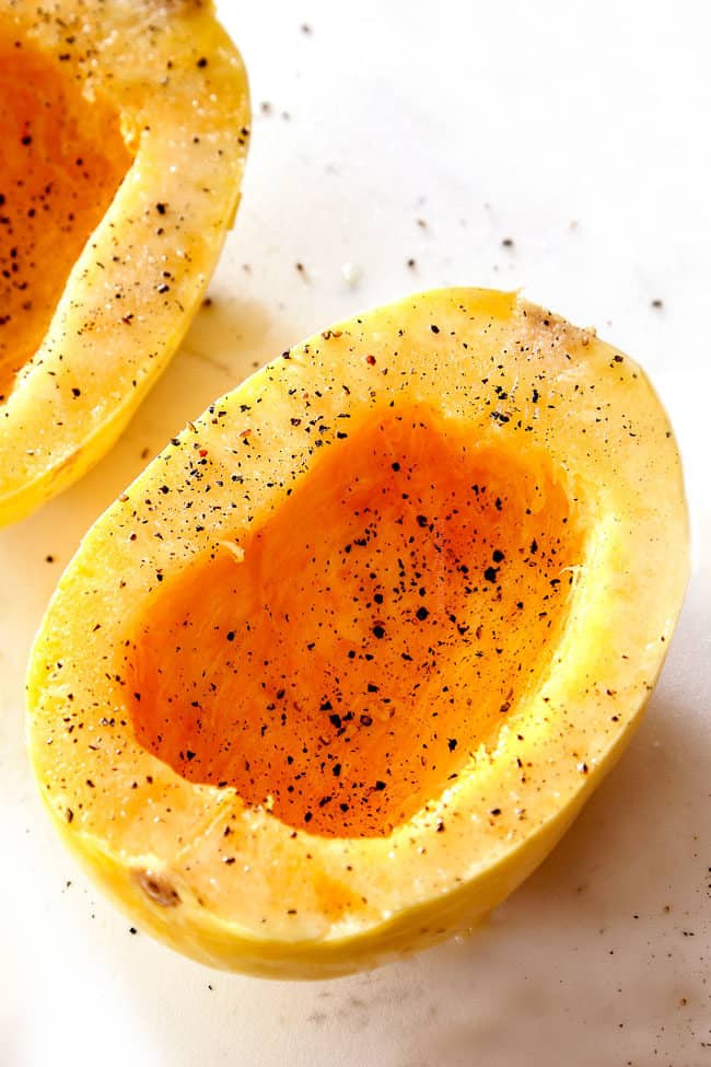 showing how to cook spaghetti squash by seasoning with salt and pepper before roasting