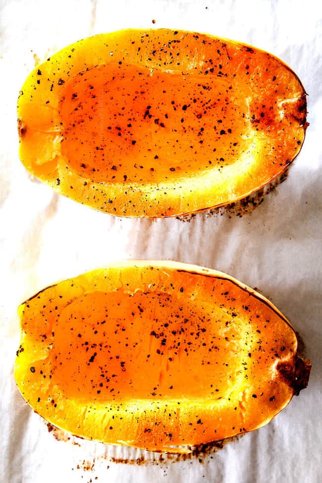 showing how to cook spaghetti squash by removing two roasted spaghetti squash halves from the oven