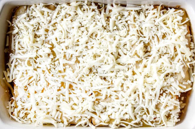 showing how to make chicken enchiladas by topping with cheese