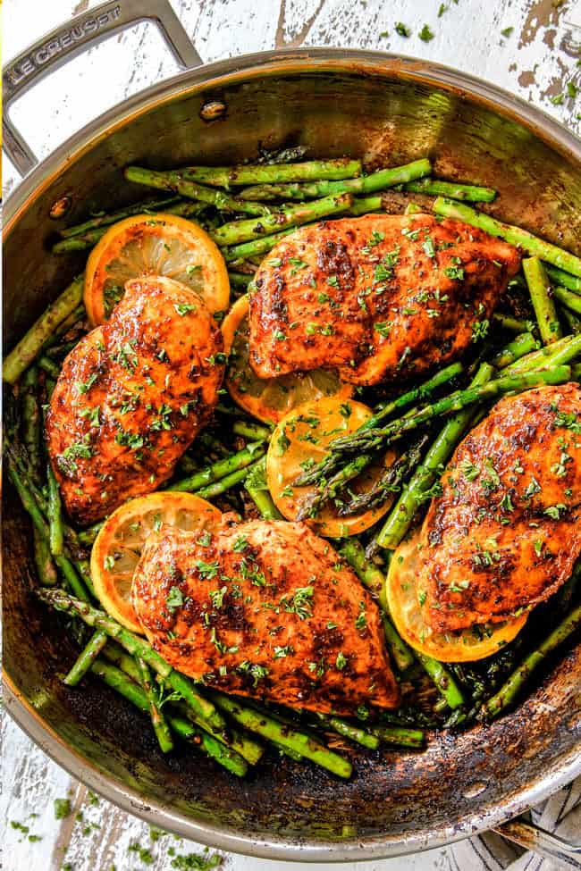 top view of lemon pepper chicken and asparagus in a skillet