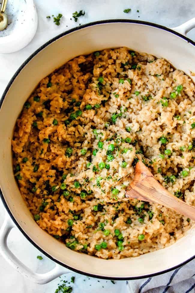 top view of garlic parmesan risotto with a wooden spoon