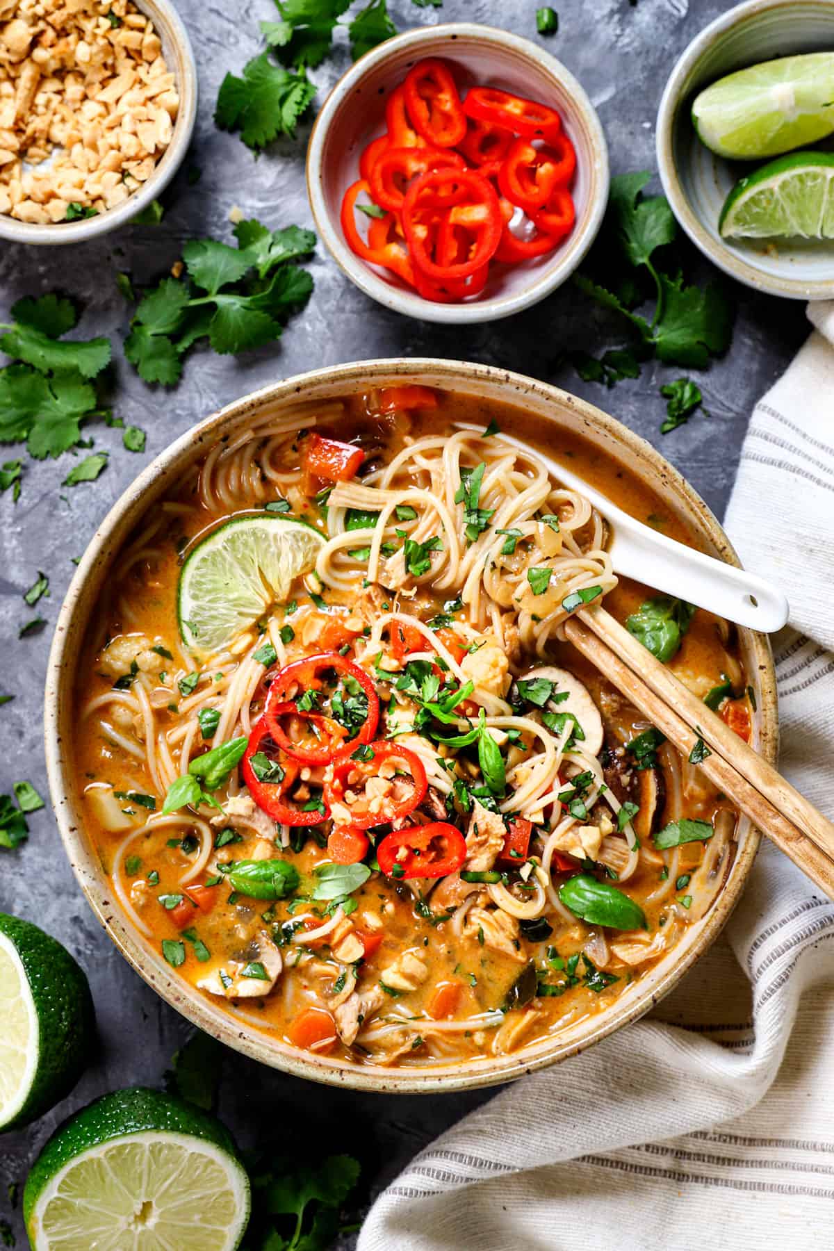 Thai noodle soup topped with cilantro, peanuts and basil