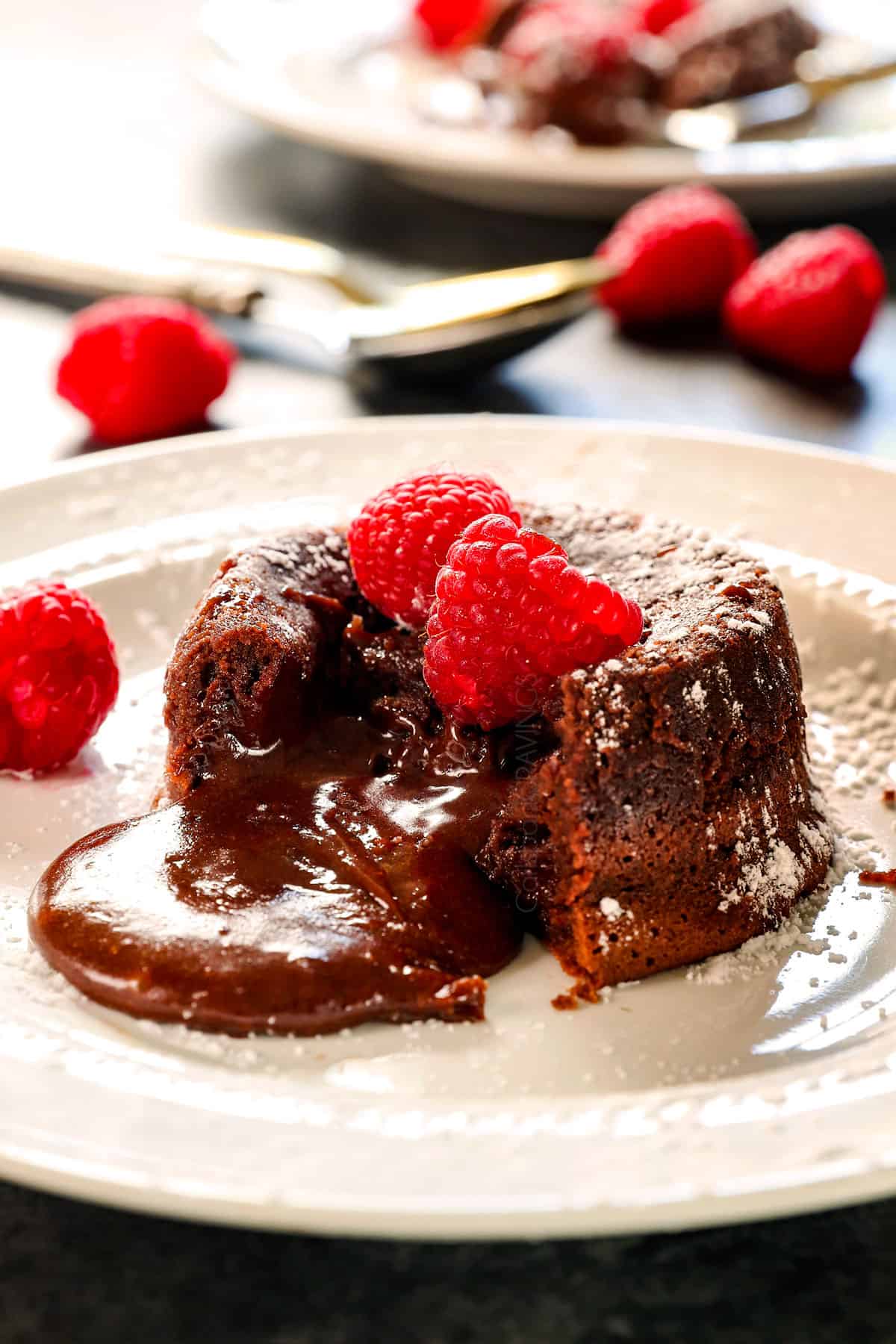 chocolate lava cake recipe on a white plate with an oozing chocolate center