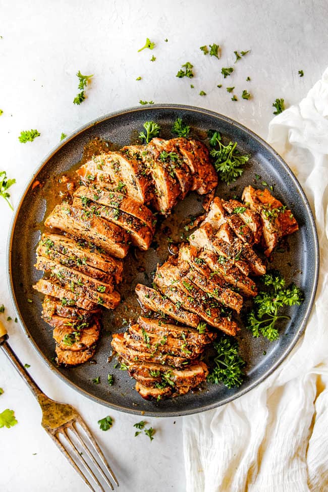 top view of easy baked pork tenderloin sliced on a round platter