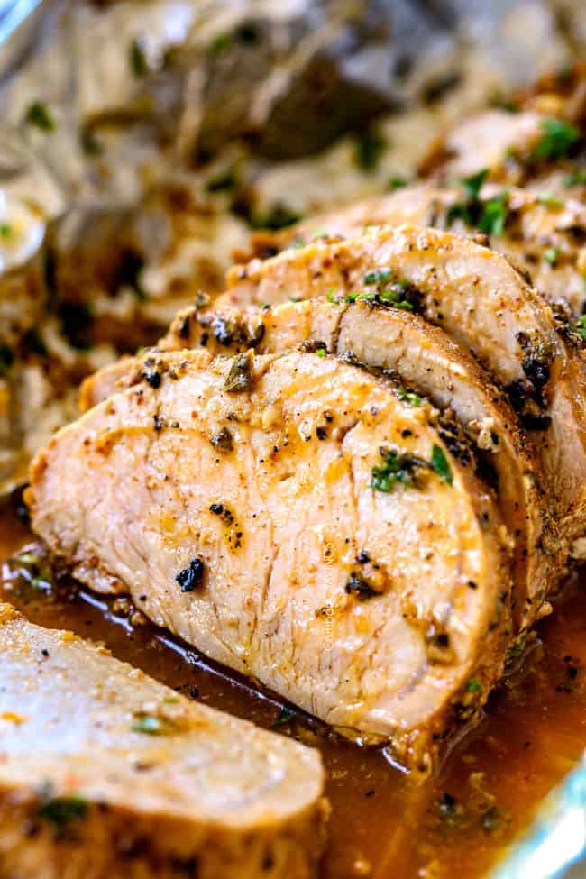 slices of easy pork tenderloin recipe on a cutting board