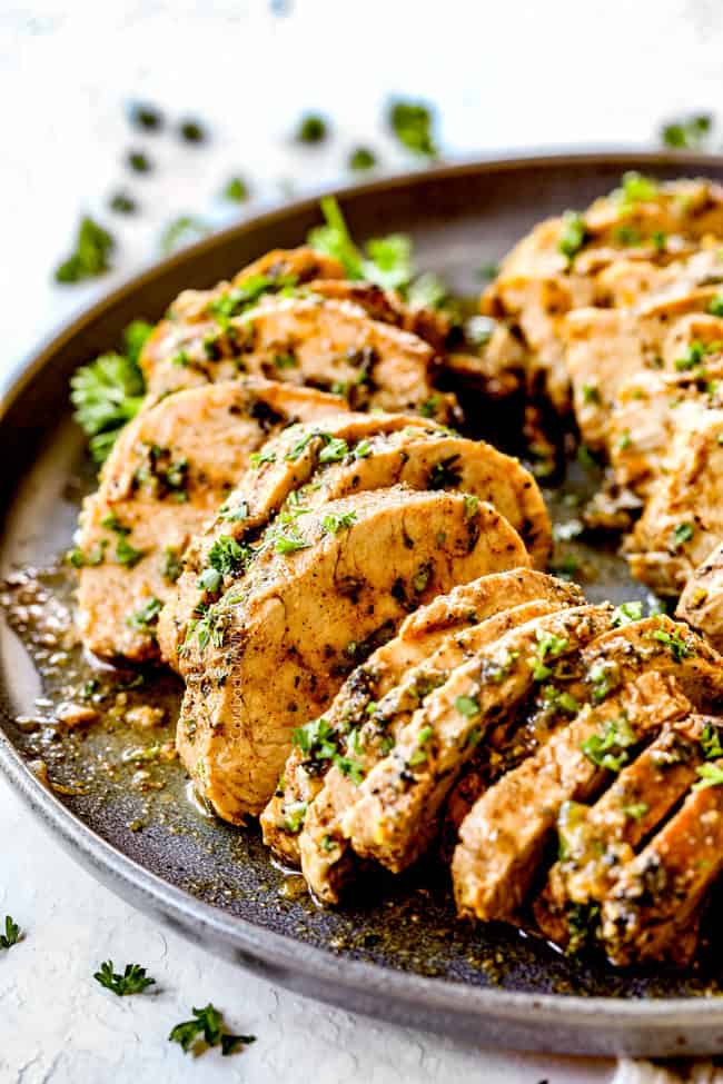 up close of sliced oven baked pork tenderloin recipe on a platter