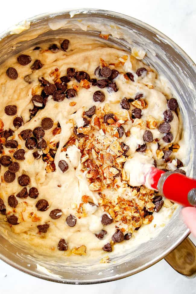 showing how to make banana cake by adding chocolate chips and walnuts to batter