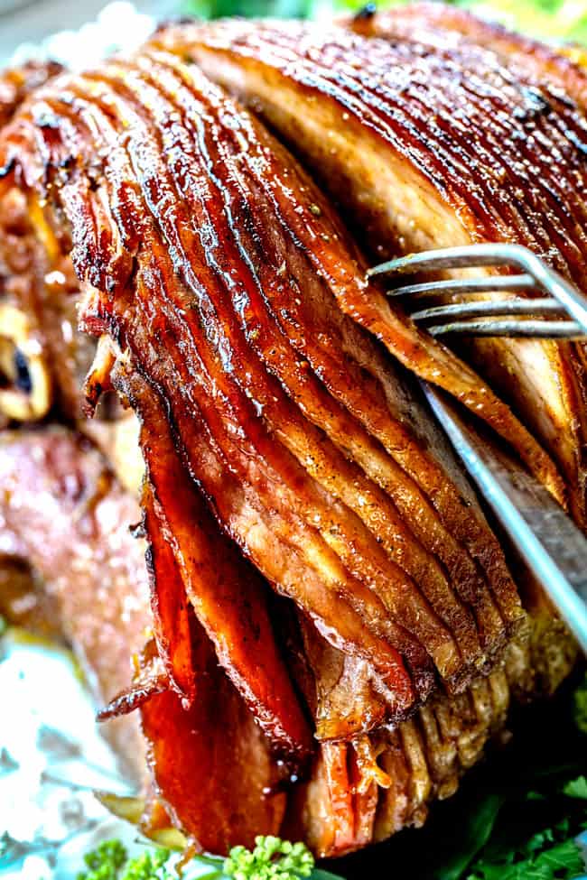 a fork and knife carving honey glazed ham