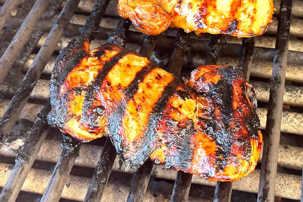 showing how to make teriyaki chicken by cooking the chicken on the grill