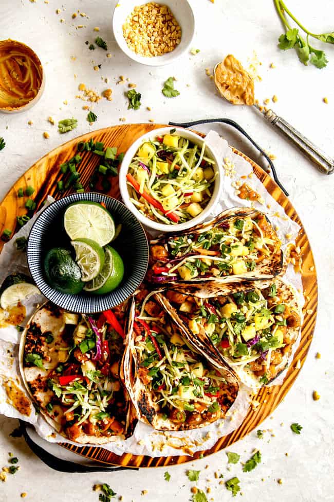 top view of Thai chicken tacos on a wood cutting board