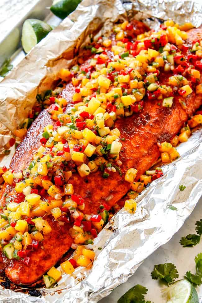 side view of salmon in foil with mango salsa