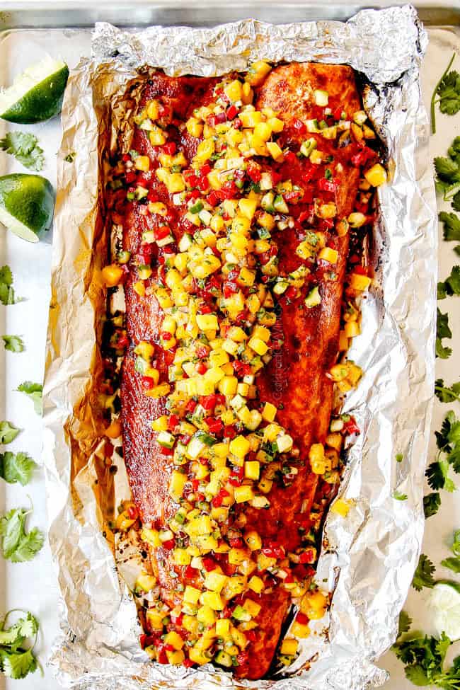 top view of bakes salmon in foil with mango salsa