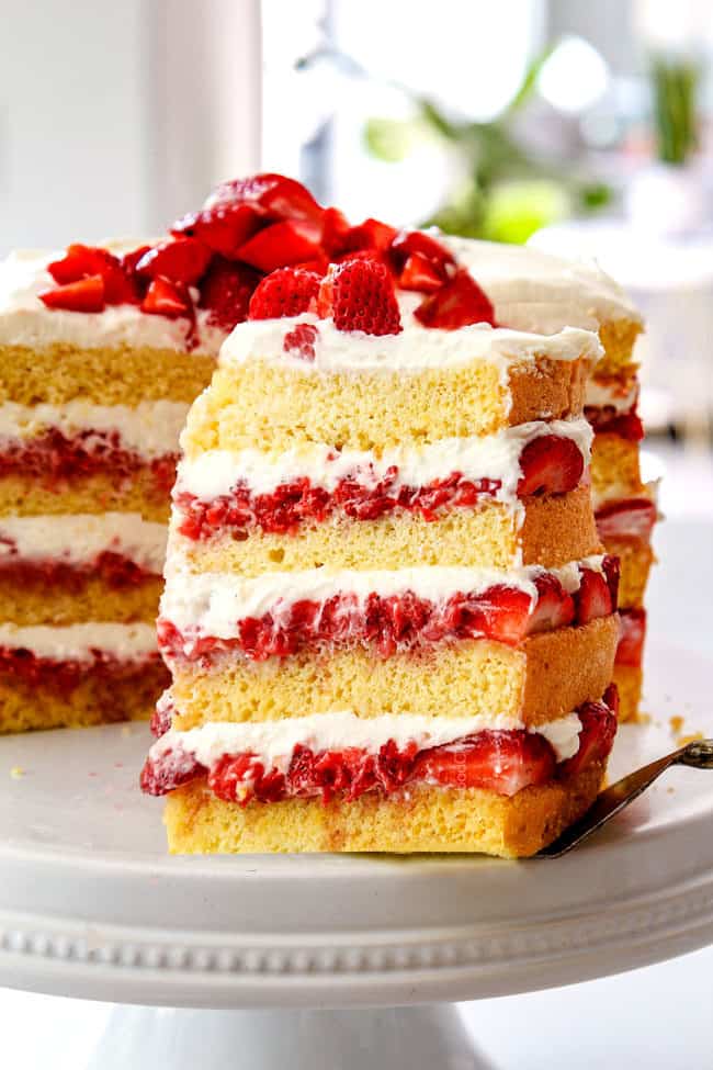 pulling out a slice of strawberry shortcake cake recipe from scratch