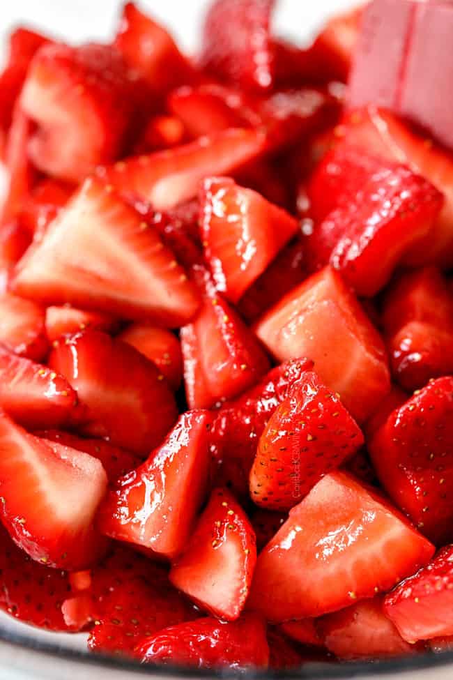 showing how to make strawberry shortcake cake by letting strawberries macerate