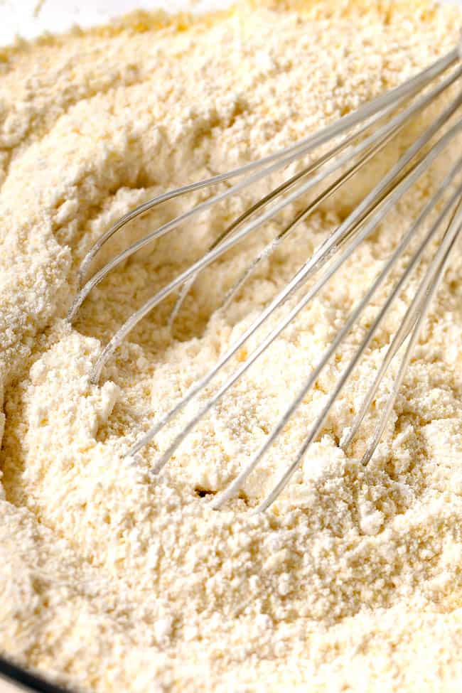 showing how to make strawberry shortcake cake by mixing flour, sugar, baking powder togther