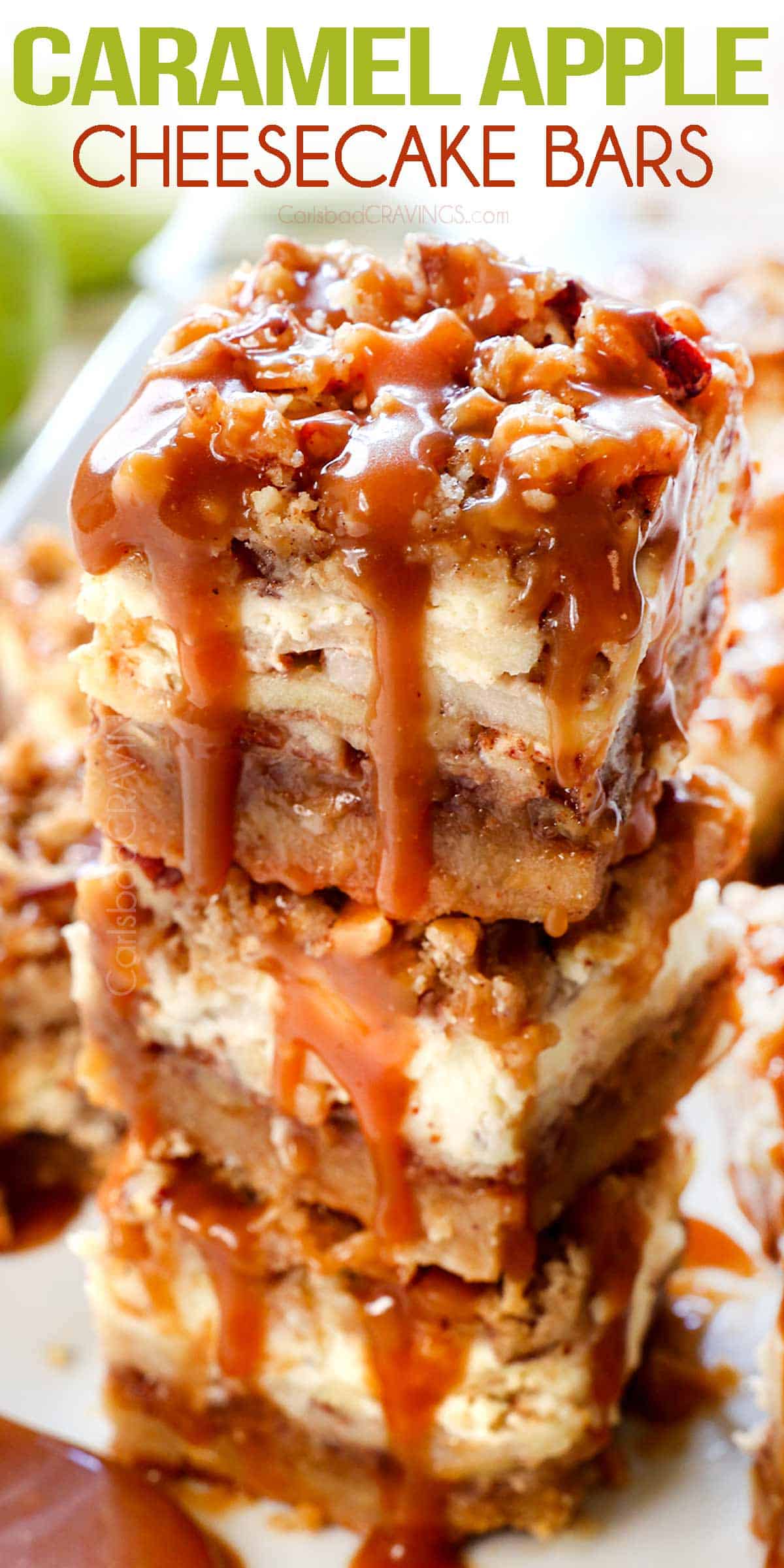 apple cheesecake bars stacked on top of each other showing the layers of shortbread crust, nuts, apples, cheesecake, streusel, and caramel