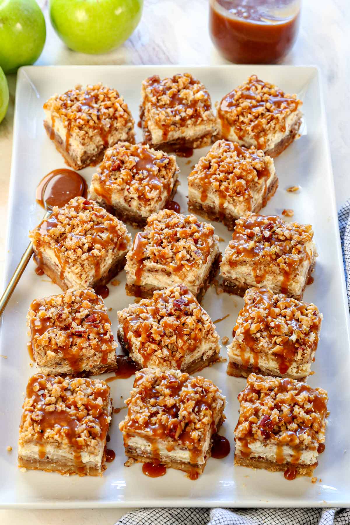 a tray of cheesecake bars drizzled with caramel