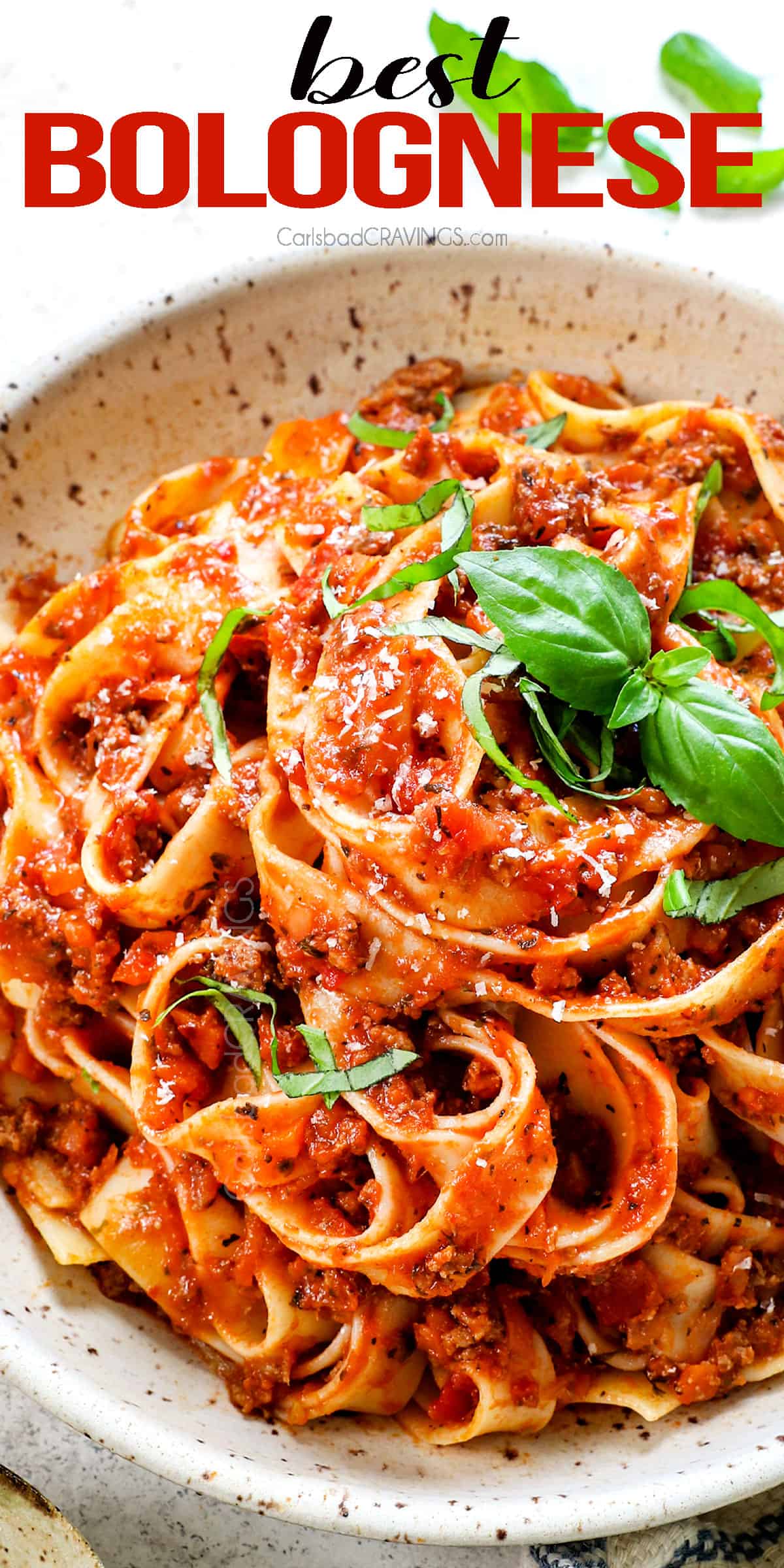 top view of Bolognese being served in a bowl with pappardelle 