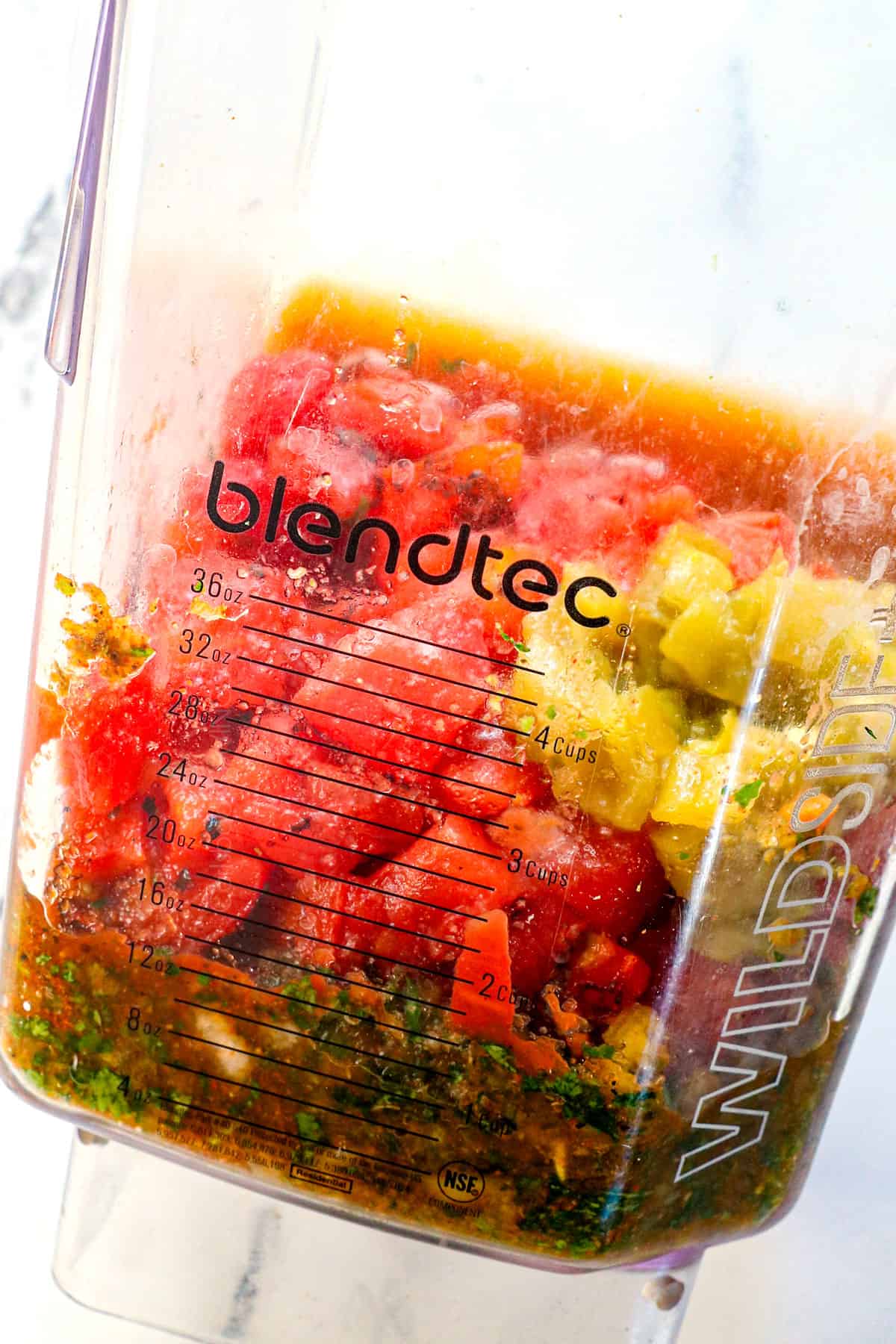 showing how to make homemade salsa by adding fire roasted tomatoes and green chiles to blender