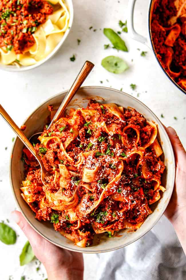 top view of two forks swirled in a bowl of pasta bolognese