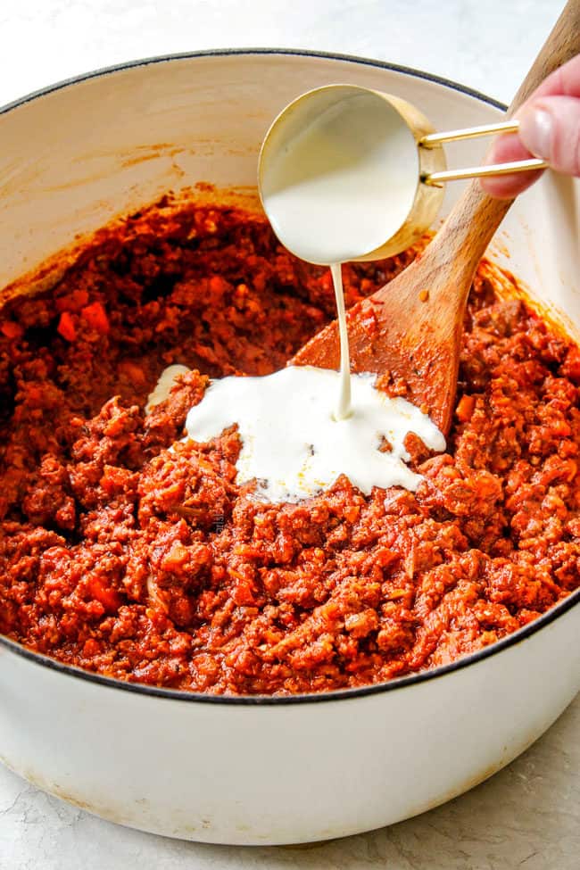 showing how to make the best bolognese sauce by adding heavy cream to the sauce