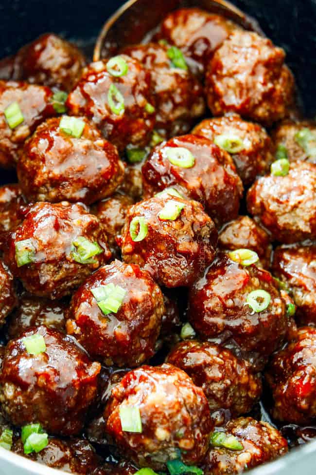 showing how to make best cranberry meatballs recipe by stirring meatballs in cranberry sauce