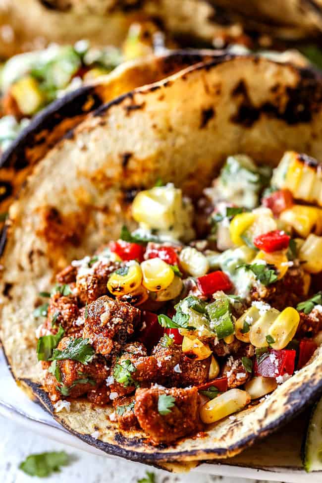 up close of pork taco recipe with corn salsa and cotija cheese