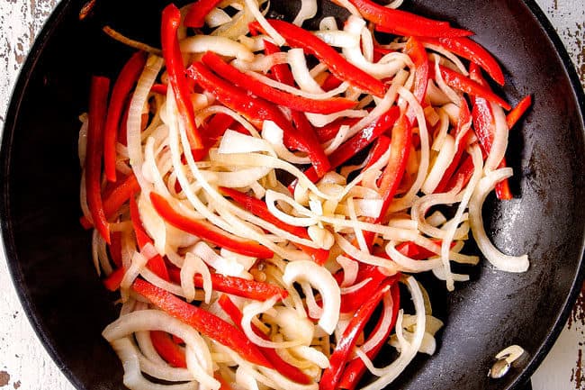 showing how to make Szechuan Beef by stir frying bell peppers and onions in a wok