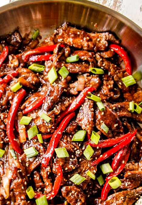 top view of crispy Szechuan beef in a work with peppers