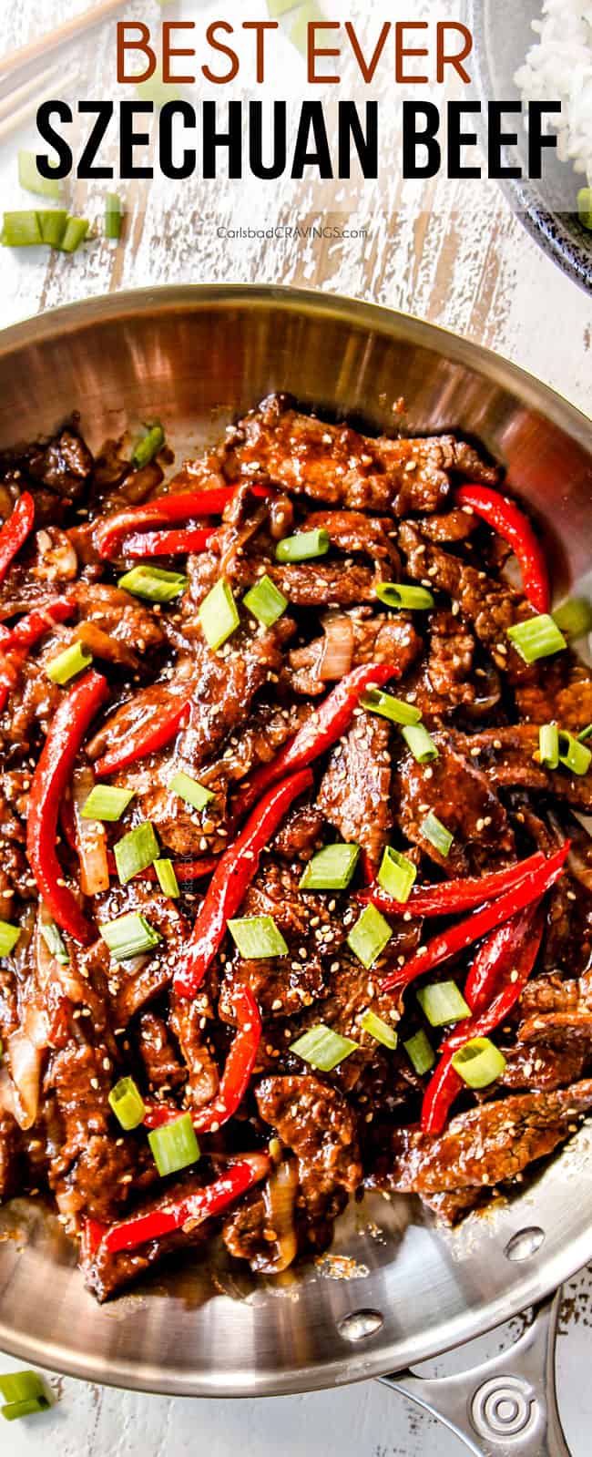 top view of crispy Szechuan beef in a work with peppers