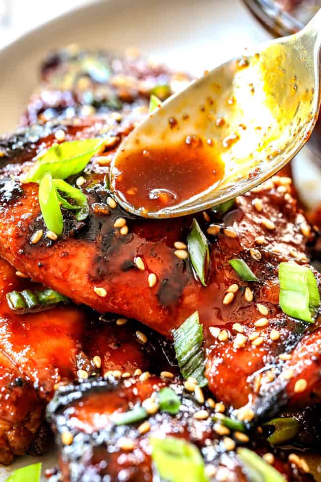 showing how to make sticky Korean Chicken by spooning glaze over chicken