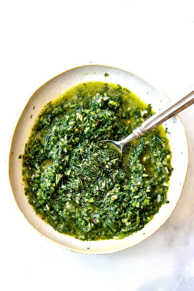 showing what to serve with grilled pork tenderloin recipe with a bowl of chimichurri