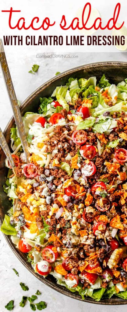 top view of taco salad with ground beef, cheese, tomatoes, lettuce, beans, taco salad dressing