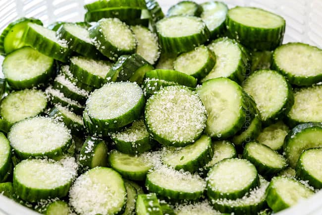 showing how to make cucumber salad by sweating cucumbers with salt