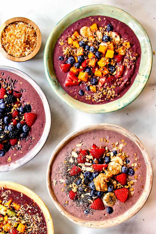 top view of homemade acai bowls topped with fresh fruit and granola