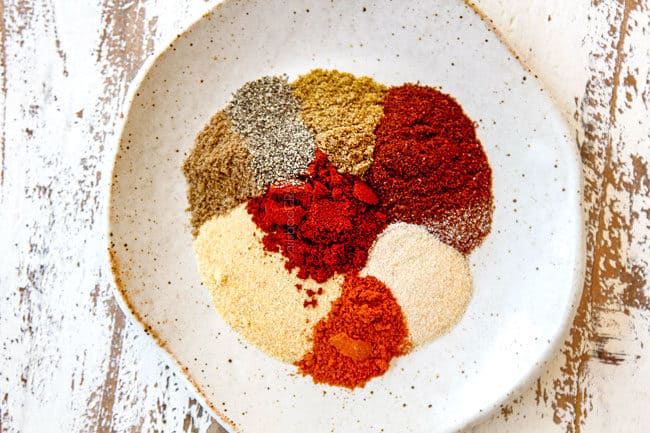 showing how to make carne asada recipe by gathering seasonings: chili powder, garlic powder, onion powder, coriander, cayenne pepper, salt