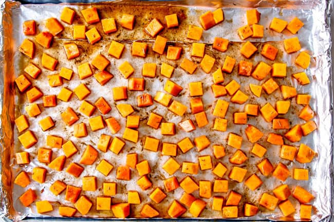 showing how to roast butternut squash by spreading into an even layer to roastt