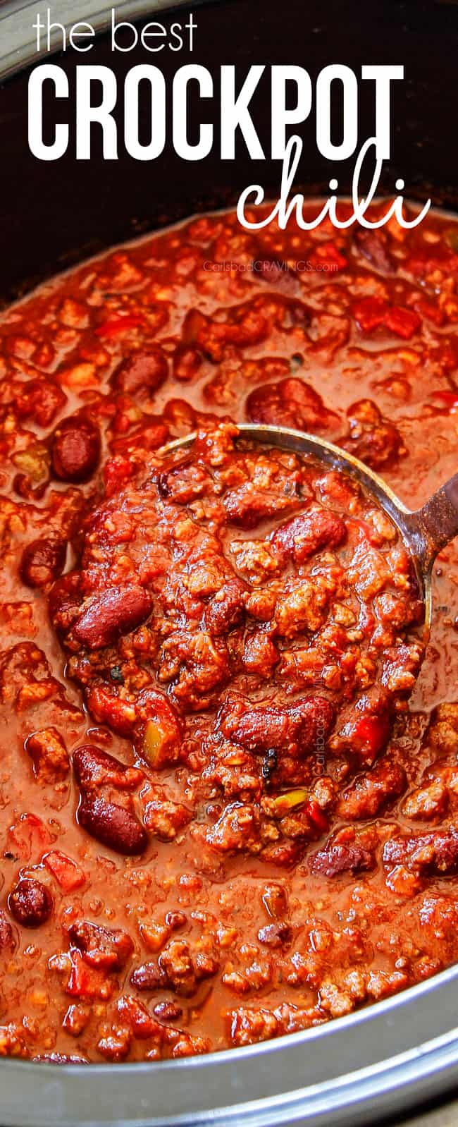 up close of a spoon scooping crockpot chili in the slow cooker