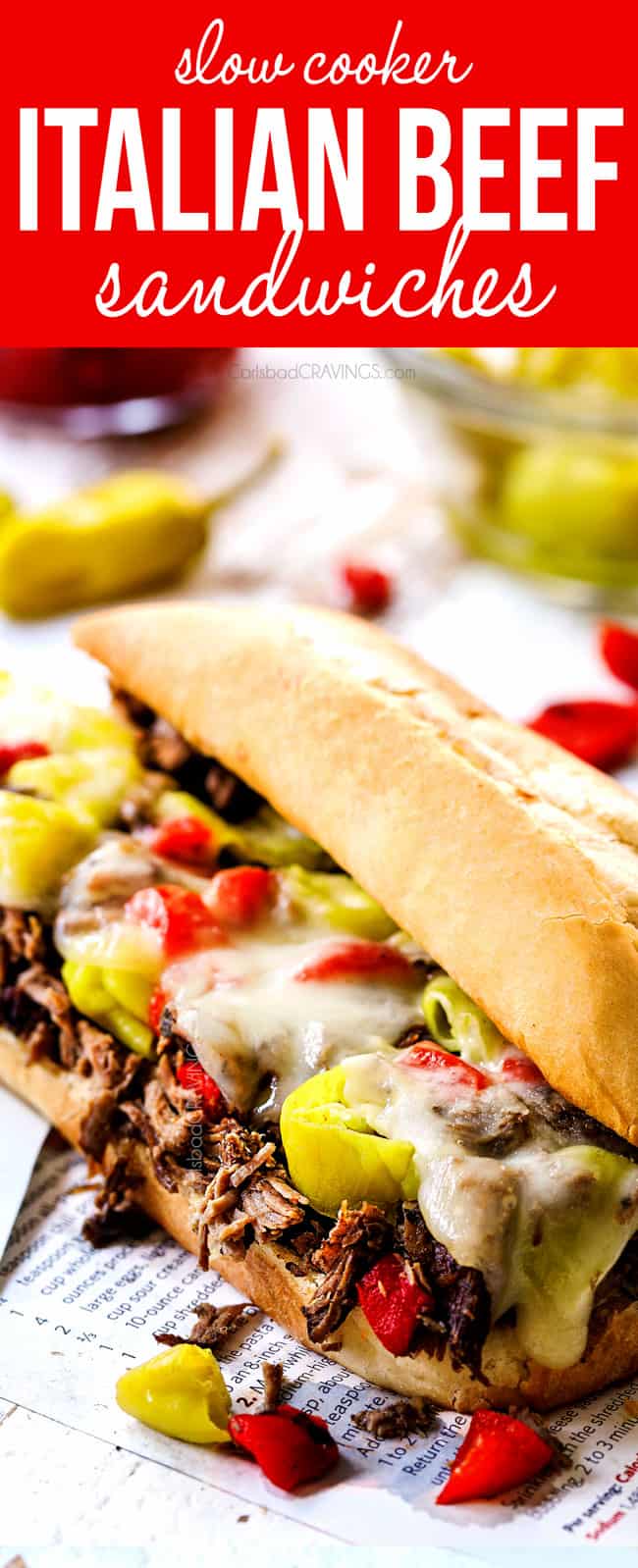 up close of crock pot Italian Beef Sandwich with cheese, pepperoncini and peppers