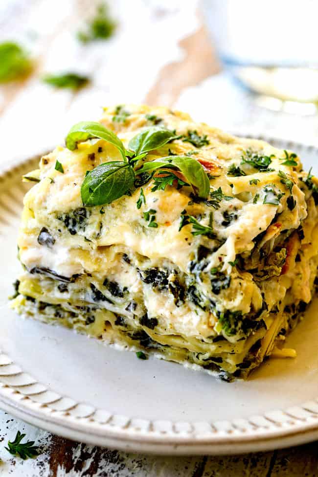 up close of a slice of chicken lasagna with spinach and artichokes