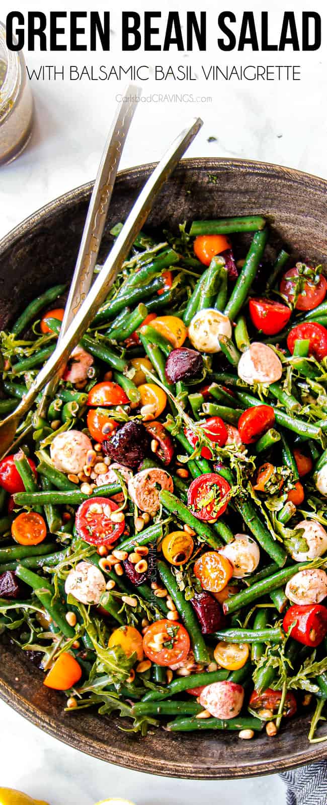 top view of green bean and tomato salad in a wood bowl