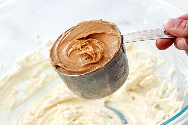 showing how to make peanut butter balls by adding peanut butter to cream cheese in a mixing bowl