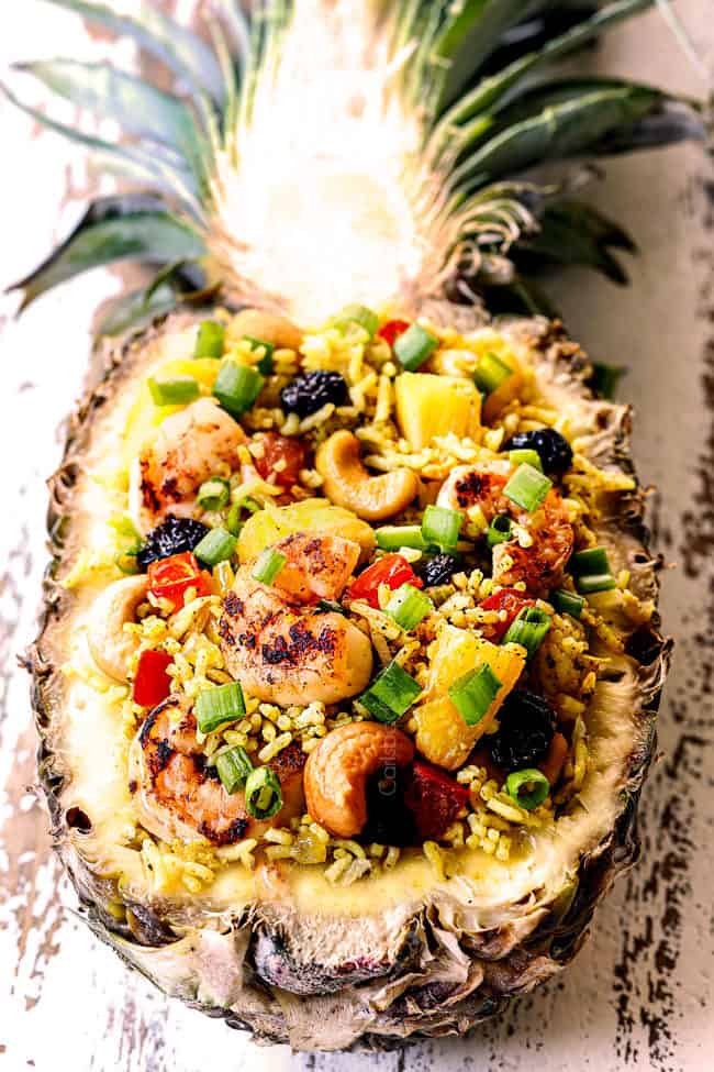 showing how to serve homemade pineapple fried rice recipe in a pineapple bowl