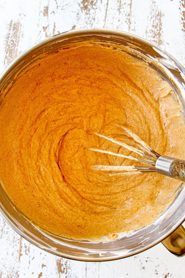 showing how to make pumpkin cheesecake bars by mixing cheesecake with pure pumpkin until well blended